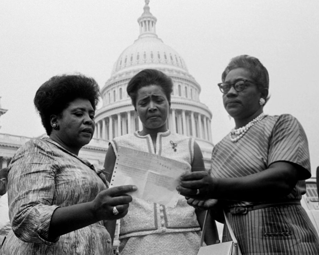 Three Women from the 1950's Looking at a Slip of Paper