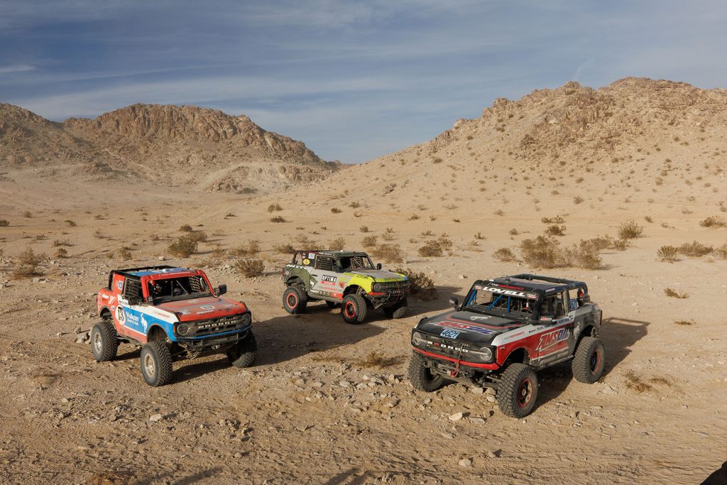 Three Ford Broncos in Front of a Desert Mountain