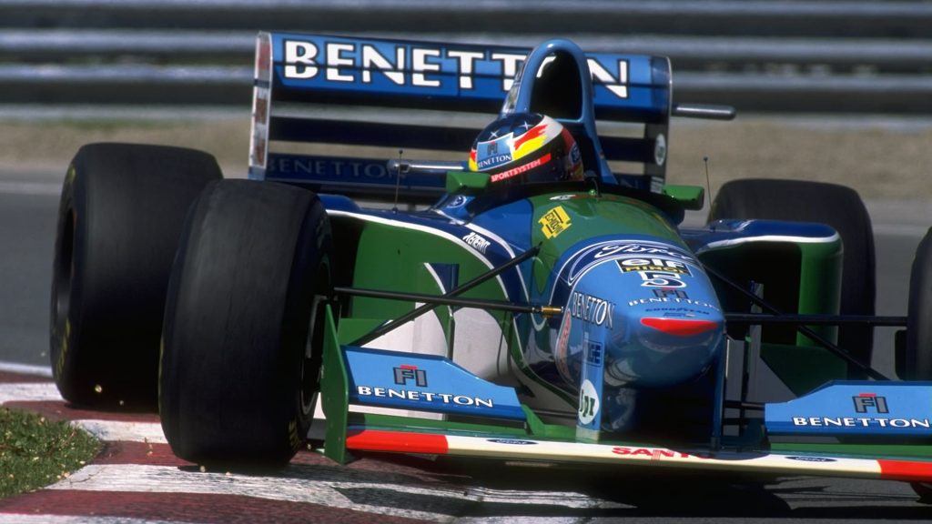 The Benetton Car coming around the curve in a formula 1 race