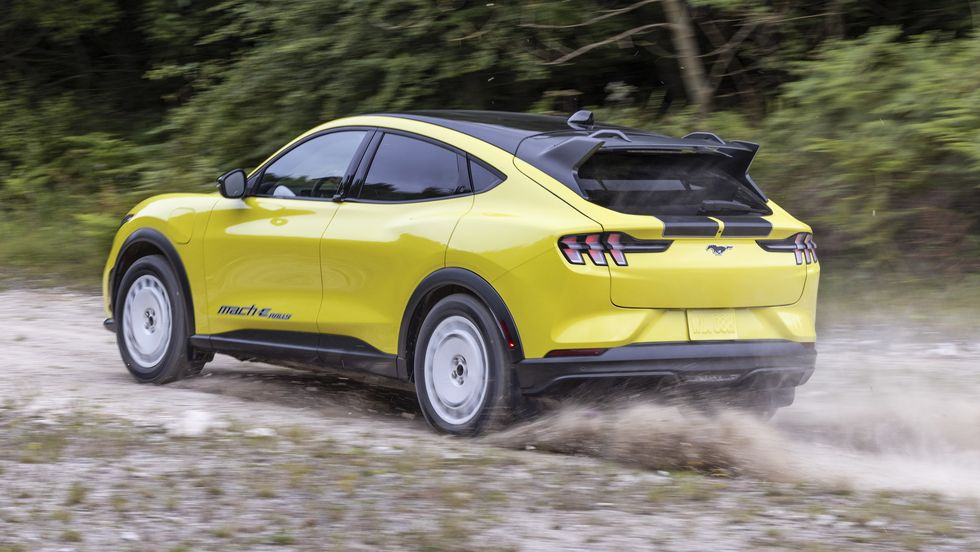 Ford Mustang Mach-E Rally Driving on a Forest Path Rear 3/4 View