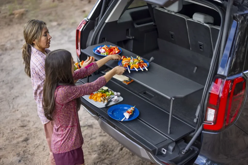 Ford Customer Using Their Ford Expedition's Split Tailgate to Prepare a Meal on a Camping Trip