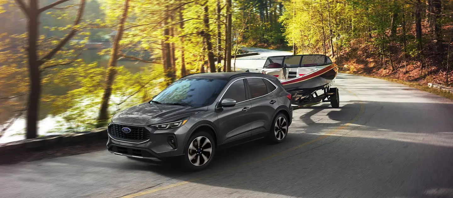 2025 Ford Escape Towing a Boat on a Mountain Road